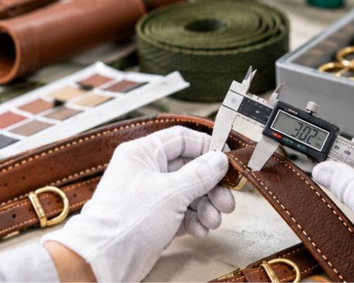 Inspector checking incoming rolls of webbing and hardware for defects