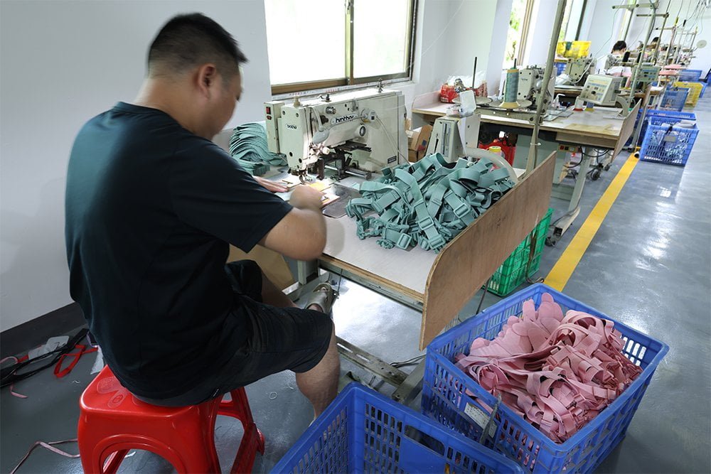 Skilled workers stitching dog collars by hand and machine